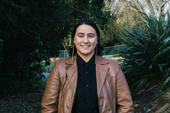 A portrait photo of Danielle Marks in front of some harakeke flax bushes